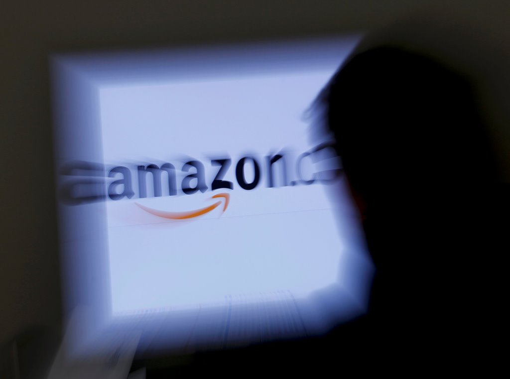 FILE PHOTO: A zoomed illustration image of a man looking at a computer monitor showing the logo of Amazon is seen in Vienna, Austria, on November 26, 2012. REUTERS/Leonhard Foeger/File Photo
