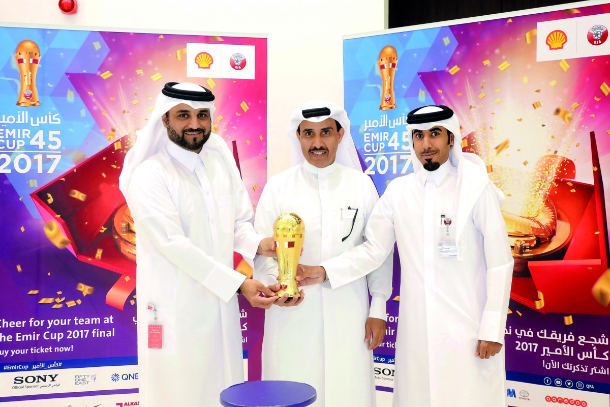 Officials with the Emir Cup. 