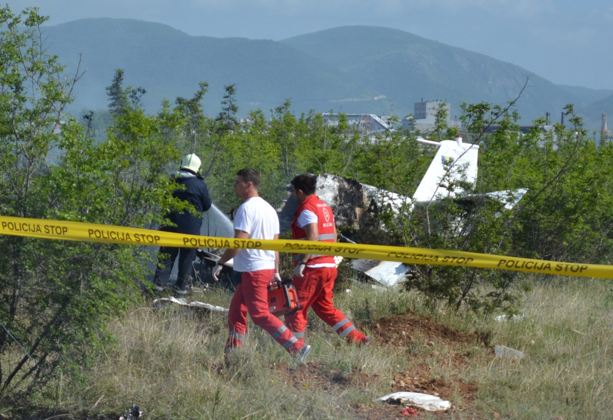 Fire brigade crew and health team work near the wreckage of a burned training plane, after it crashed near Radoc town in Mostar, Bosnia and Herzegovina on May 13, 2017. (Zeljko Milicevic / Anadolu Agency)

