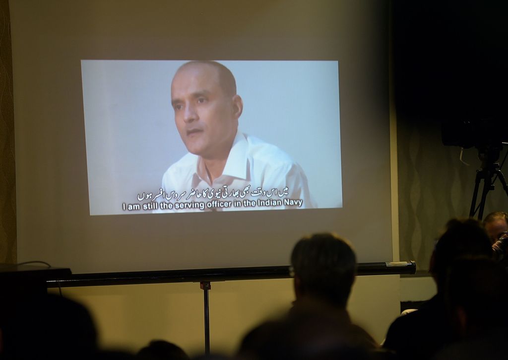 (FILES) This file photo taken on March 29, 2016 shows Pakistani journalists watching a video showing Indian national Kulbhushan Yadav, arrested on suspicion of spying, during a press conference in Islamabad. India on May 15, 2017 appealed to the UN's top 