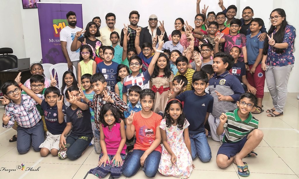 Students and parents with music legends at Music Lounge centre for training in Wakrah. 