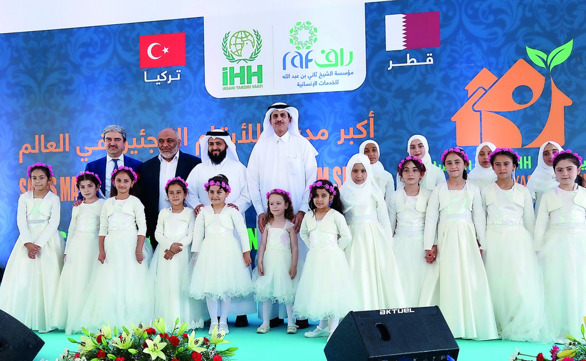 Sheikh Dr Khalid bin Thani Al Thani, Chairman of Sheikh Thani bin Abdullah Foundation for Humanitarian Services (RAF), with other officials and Syrian orphans, during the opening of RAF-IHH City for Human Development, in Al Raihaniya, Turkey, yesterday.