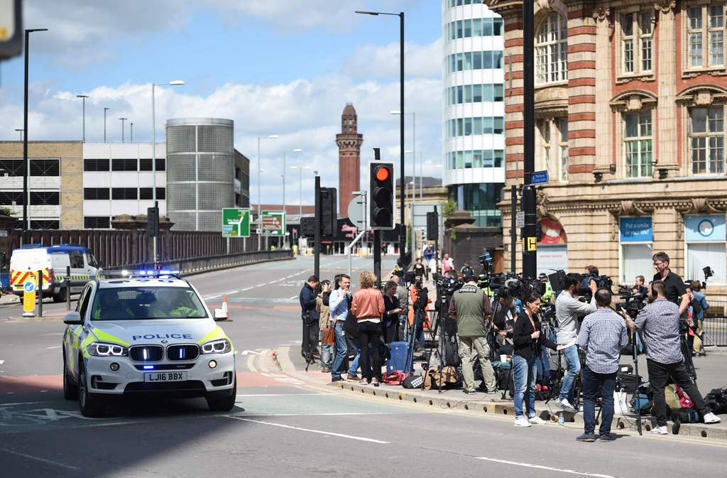 Members of the media gather at a police cordon close to the Manchester Arena in Manchester, northwest England on May 23, 2017 following a deadly terror attack at the Ariana Grande concert at the Manchester Arena the night before.  AFP / Oli SCARFF