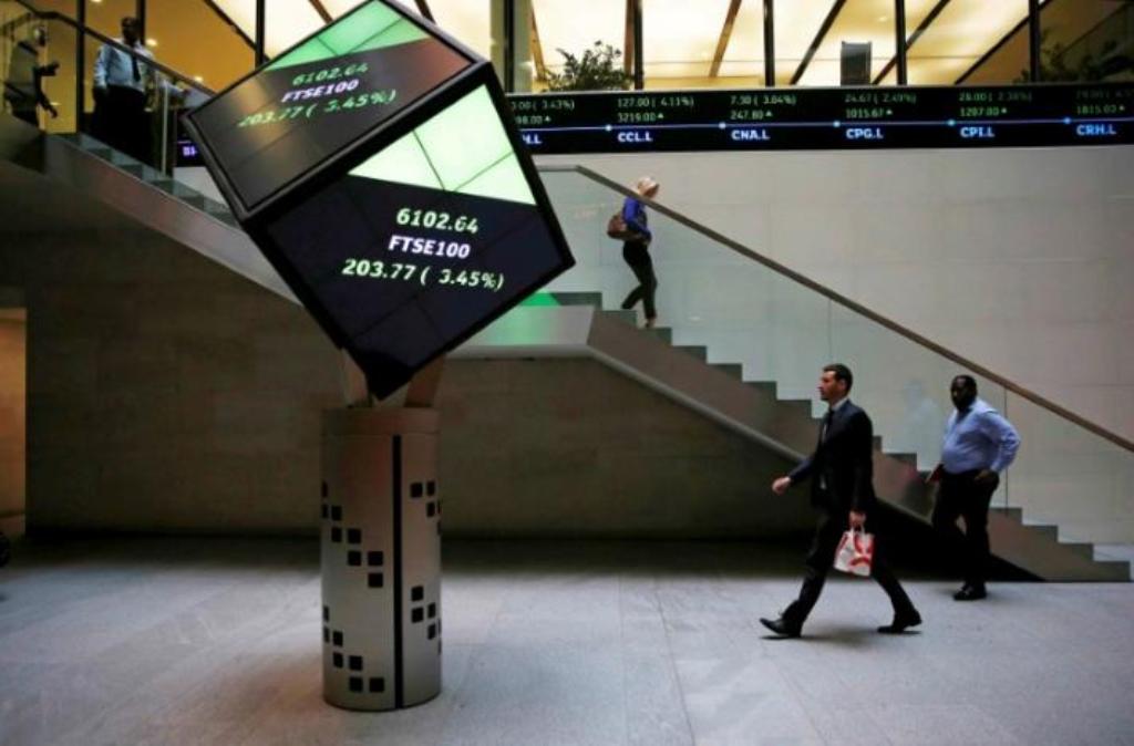 People walk through the lobby of the London Stock Exchange in London, Britain
