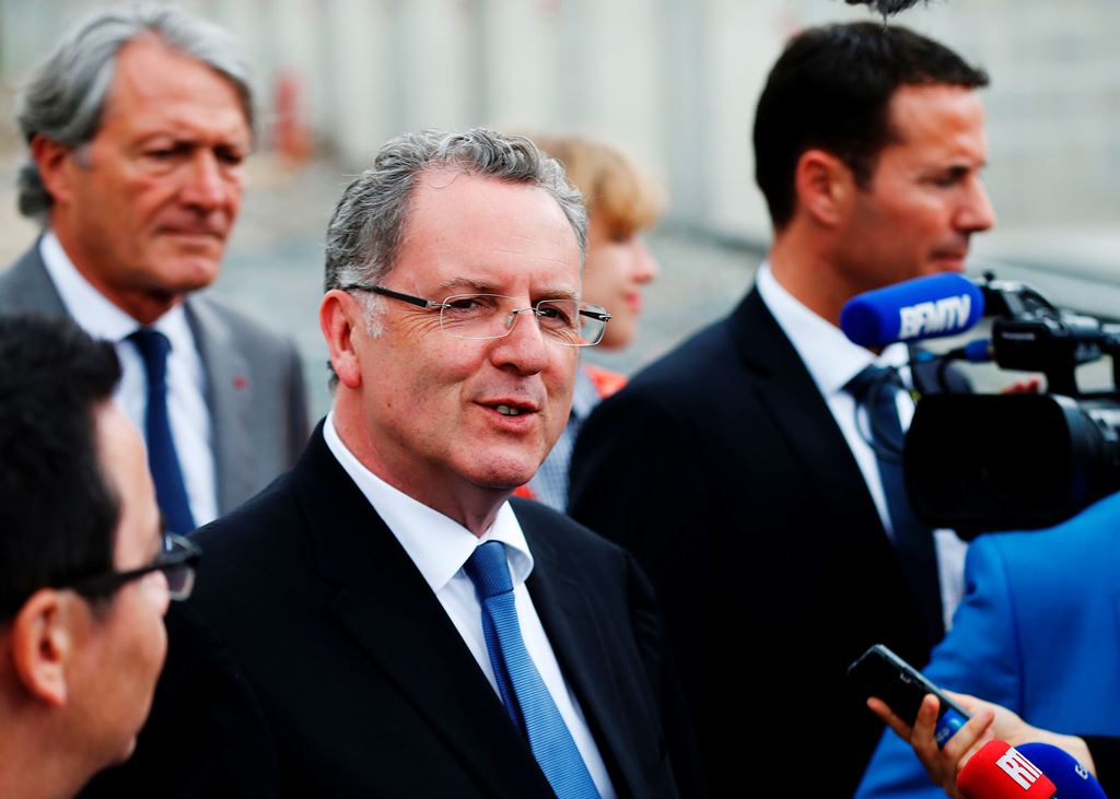 France's Minister of Territorial Cohesion Richard Ferrand (C), flanked by Mayor of Deauville Philippe Augier (L), speaks to journalists in Deauville, northwestern France, on May 29, 2017. AFP / Charly Triballeau 
