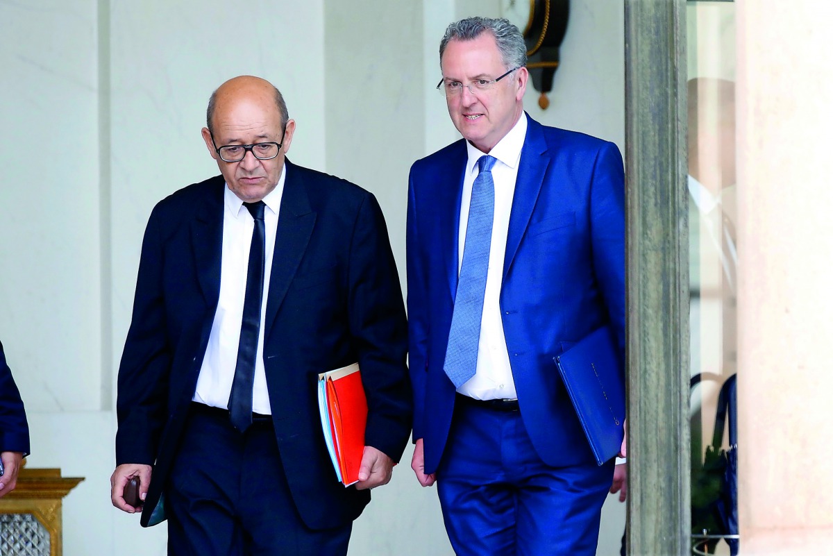 French Minister of Europe and Foreign Affairs Jean-Yves Le Drian (L) and Territorial Cohesion Minister Richard Ferrand (R) leave the Elysee Palace after a weekly cabinet meeting in Paris, France, May 31, 2017. Reuters/Charles Platiau