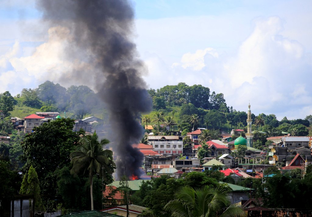 Smoke billowing from a burning building is seen as government troops continue their assault on insurgents from the Maute group, who have taken over large parts of Marawi City, Philippines June 1, 2017. REUTERS/Romeo Ranoco