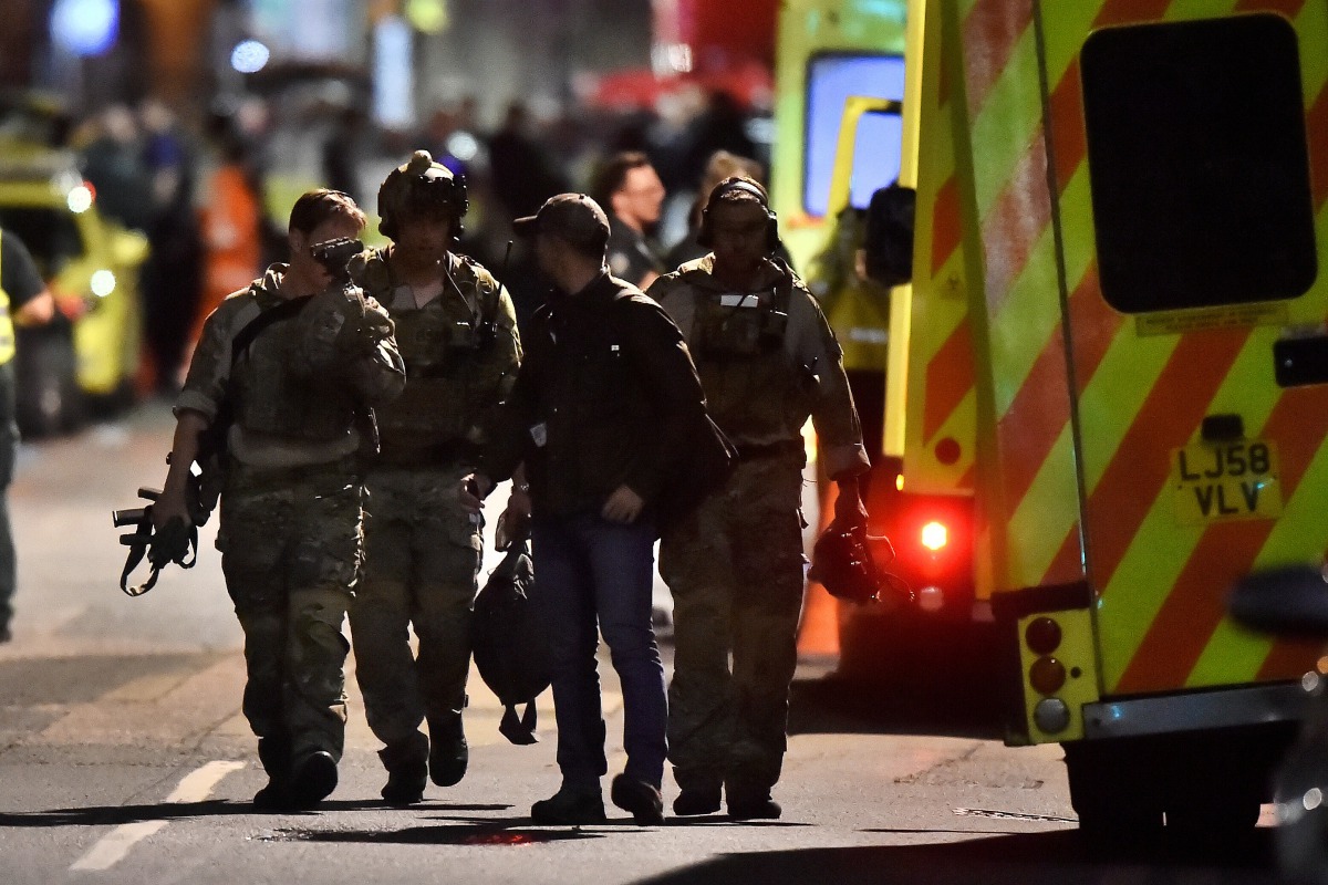 Armed officers attend to an incident near London Bridge in London, Britain, June 4, 2017. REUTERS/Hannah McKay
