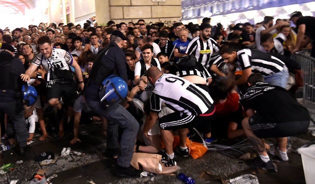 Football Soccer - Juventus v Real Madrid - UEFA Champions League Final - San Carlo Square, Turin, Italy - June 3, 2017 Juventus' fans run away from San Carlo Square following panic created by the explosion of firecrackers as they was watching the match on