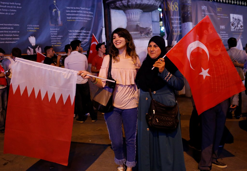 Women pose with Turkish and Qatari flags during a demonstration in favour of Qatar in central Istanbul, Turkey, late June 7, 2017. Reuters/Murad Sezer
