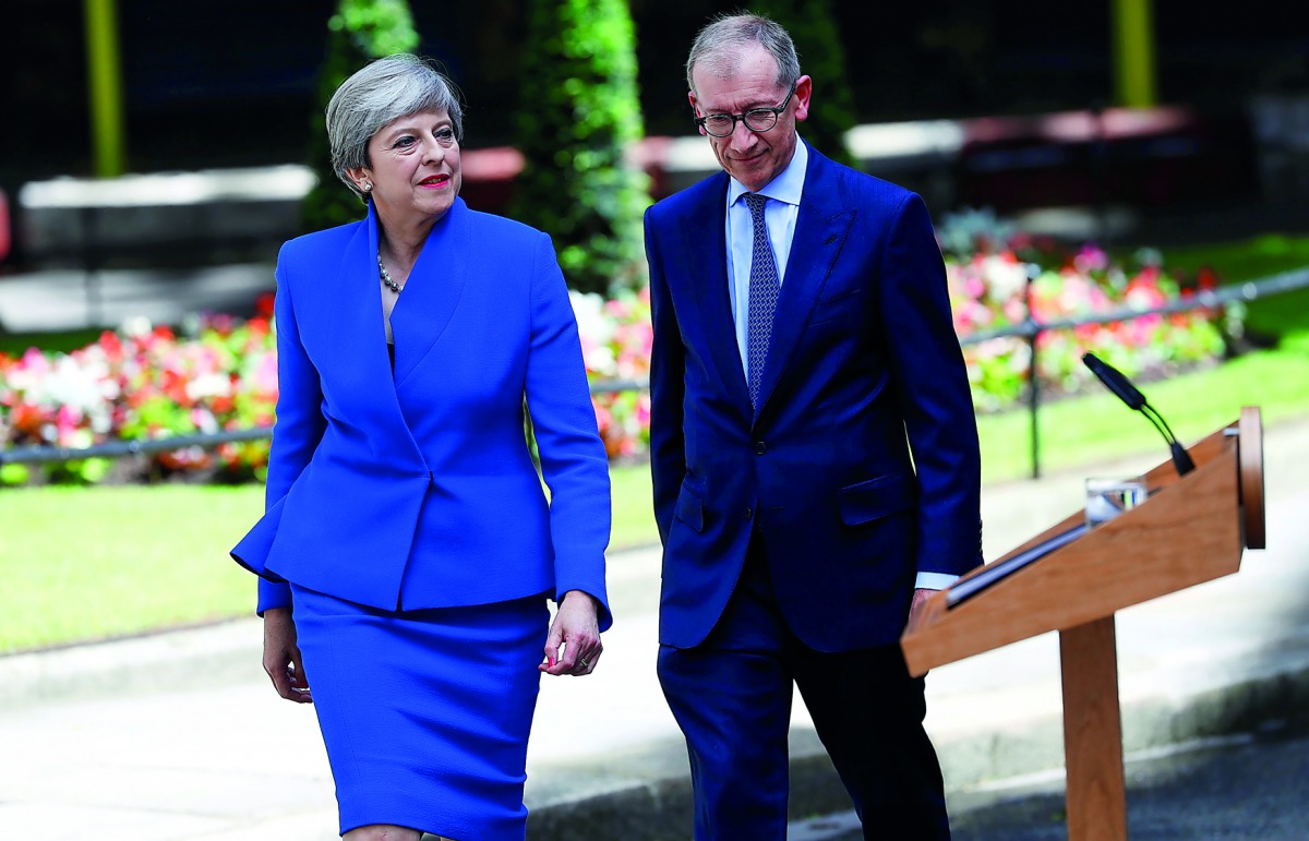 Britain's Prime Minister Theresa May returns to Downing Street with her husband Philip after travelling to Buckingham Palace to ask the Queen's permission to form a minority government, in London, yesterday. 