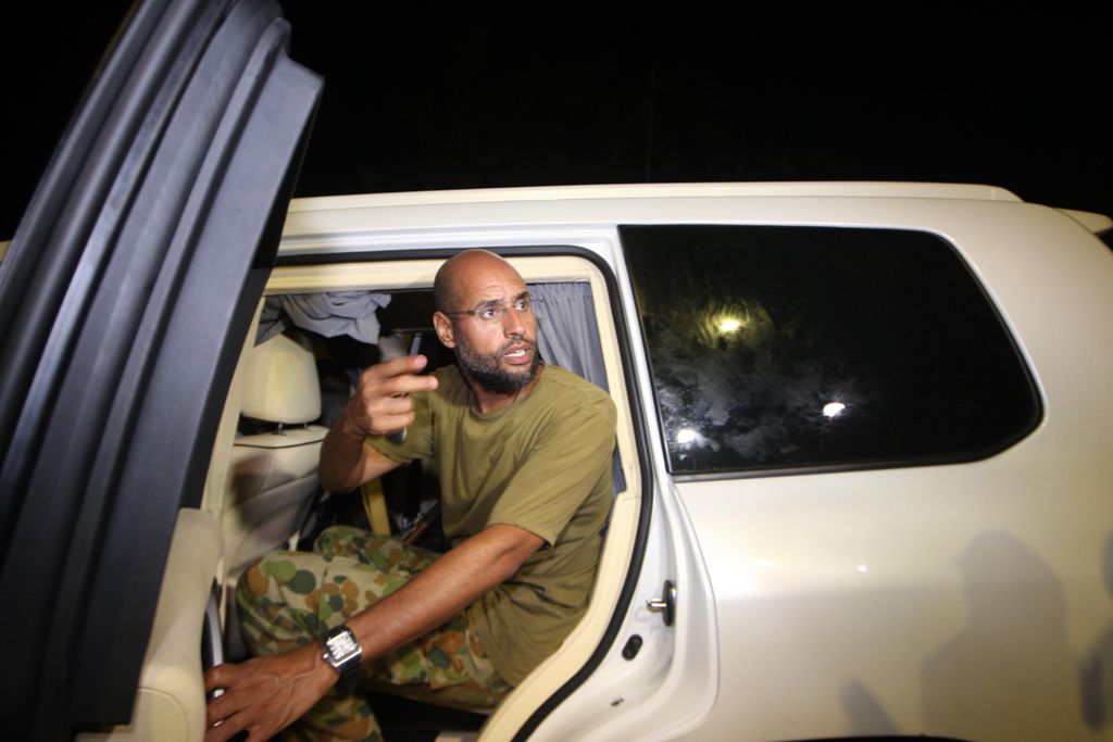 This file photo taken on August 23, 2011 shows Saif al-Islam Kadhafi, son of Libyan leader Moamer Kadhafi, appearing in front of supporters and journalists at his father's residential complex in the Libyan capital Tripoli. / AFP.
