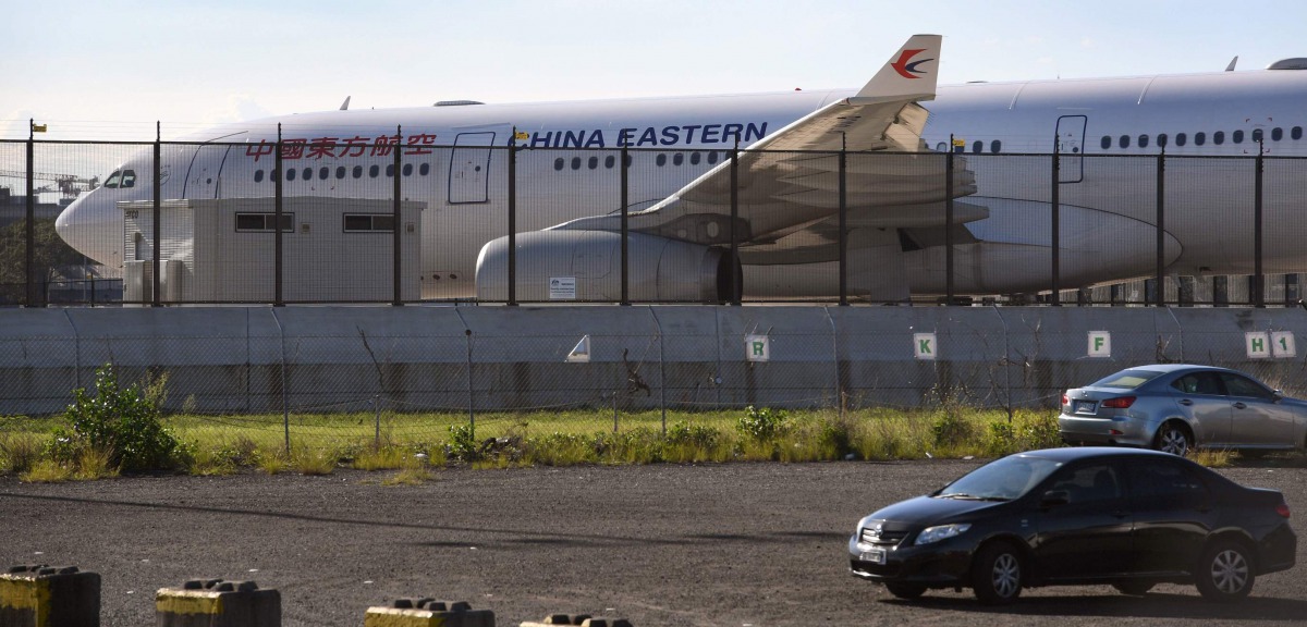 A China Eastern Airbus A330 passenger aircraft, which suffered a serious fault to its starboard engine following take-off, sits on the tarmac at Sydney Airport on June 12, 2017. The plane suffered a serious fault that tore a huge hole in one of its engine