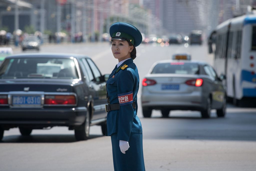 In a photo taken on June 5, 2017 a traffic security officer stands on duty at an intersection in Pyongyang. AFP / Ed Jones