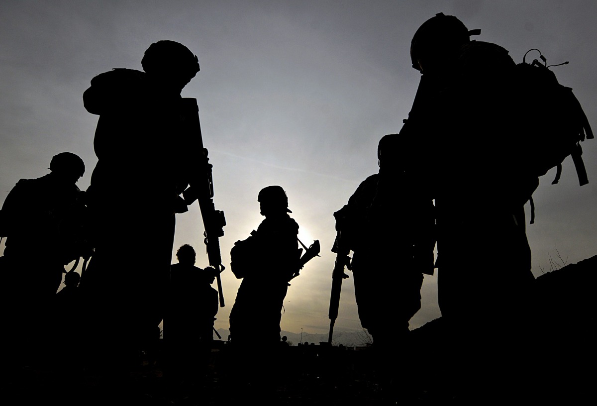 This photo taken on February 28, 2009 shows US soldiers with the NATO-led International Security Assistance Force (ISAF) silhouetted as they walk during a patrol outside Bagram Airbase, some 50 km north of Kabul. Three American troops were wounded on June
