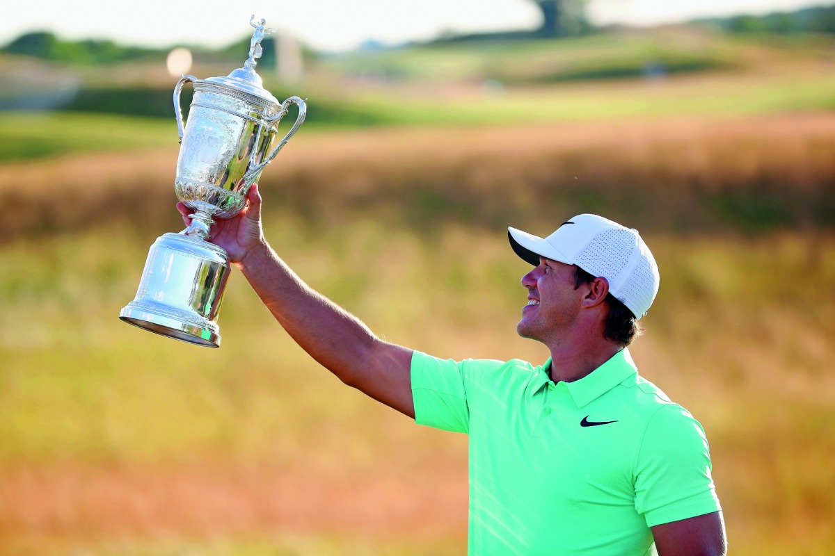 Brooks Koepka of the United States poses with the winner's trophy after his victory at the US Open at Erin Hills in Hartford, Wisconsin on Sunday.