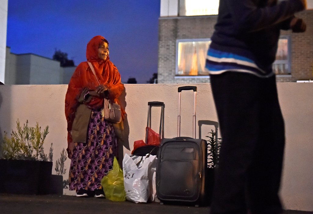 Residents are evacuated from the Taplow Tower residential block as a precautionary measure following concerns over the type of cladding used on the outside of the building on the Chalcots Estate in north London, Britain, June 23, 2017. REUTERS/Hannah McKa