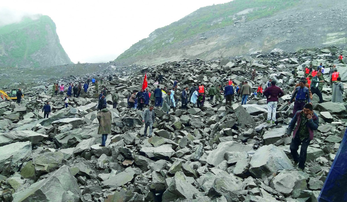 Chinese military police and rescue workers at the site of a landslide in Xinmo village, Sichuan province, yesterday.