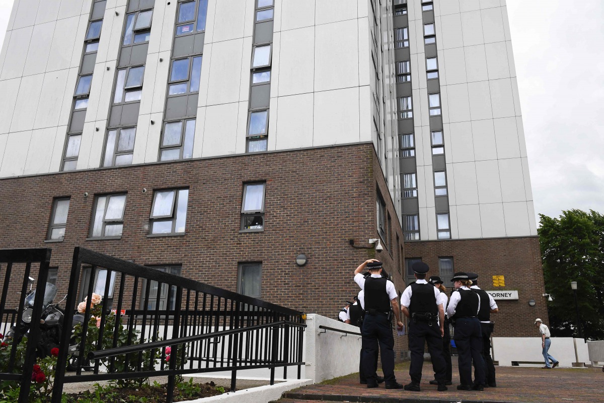 Police officers gather for a briefing outside Dorney Tower residential block on the Chalcots Estate in north London on June 25, 2017. Thousands of residents from 650 London flats were evacuated on June 24 due to fire safety fears in the wake of the Grenfe