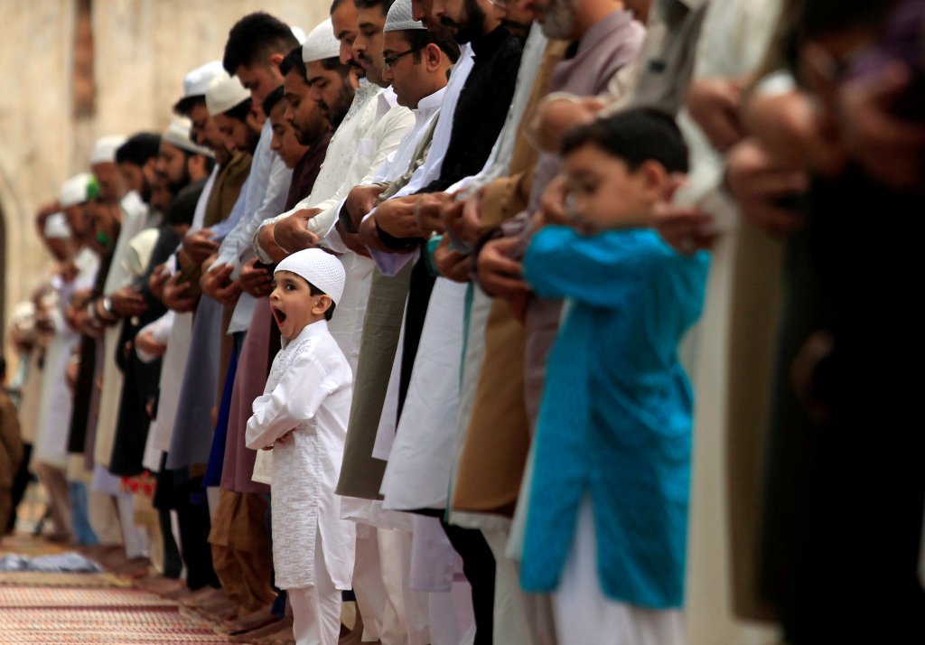 Men and children attend the Eid al-Fitr prayers to mark the end of the holy fasting month of Ramadan at a mosque in Rawalpindi, Pakistan June 26, 2017. REUTERS/Faisal Mahmood