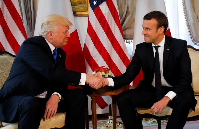 FILE PHOTO: President Trump and French President Emmanuel Macron shake hands. REUTERS/Jonathan Ernst