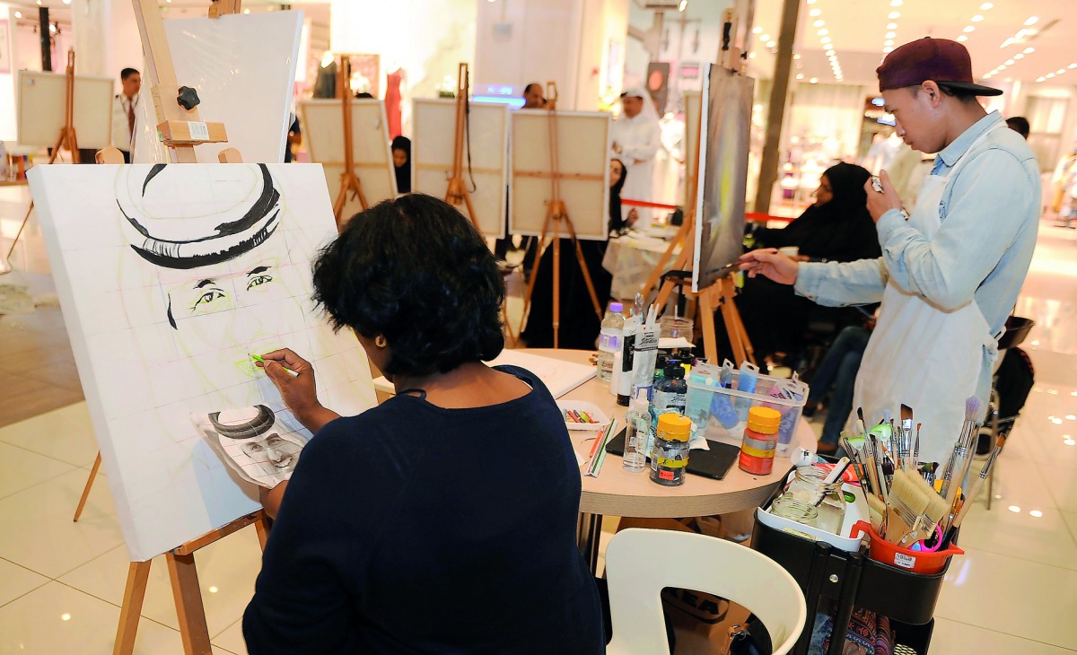 People take part in a drawing event at Gulf Mall. Pic: Abdul Basit / The Peninsula