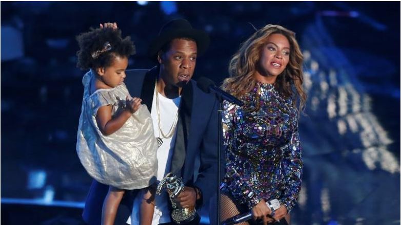 FILE PHOTO - Jay-Z with wife Beyonce as he holds their daughter Blue Ivy during the 2014 MTV Video Music Awards in Inglewood, California. REUTERS/Mario Anzuoni/File Photo