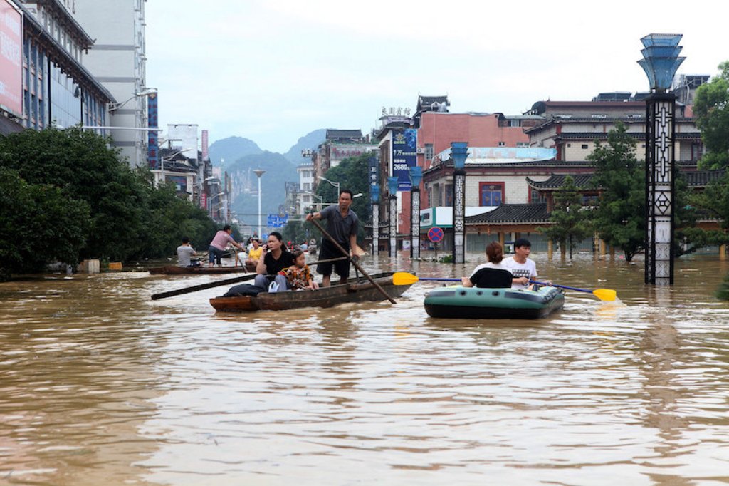 People make their way with boats through a flooded area in Liuzhou, Guangxi province July 2, 2017. — Reuters pic.