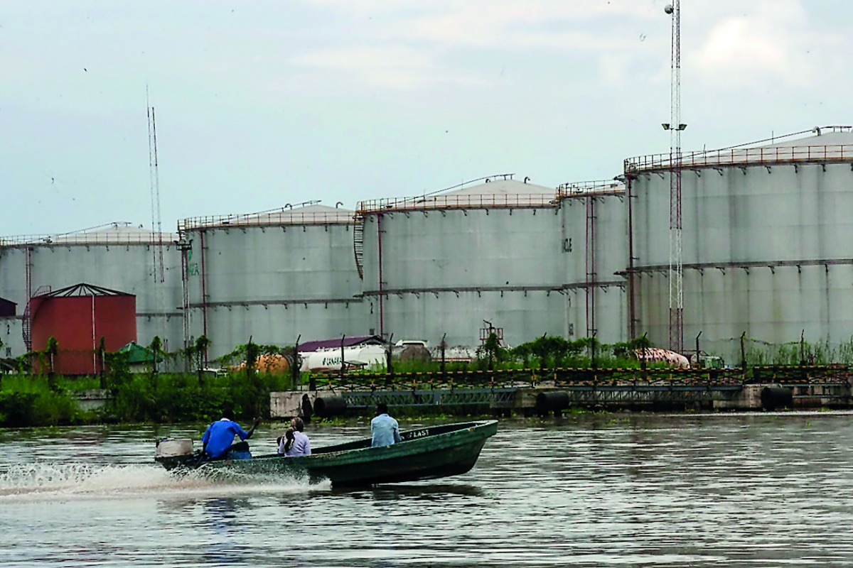 A boat travels down a river near the southeastern oil city of Warri, in Delta state, Nigeria 