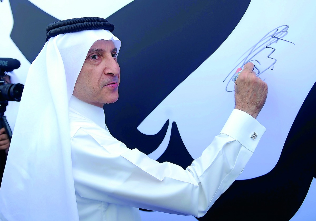 Qatar Airways Group Chief Executive Akbar Al Baker signing on 'Tamim Al Majd' banner, at Qatar Airways Tower 2 in Doha, yesterday. Pic: Baher Amin / The Peninsula