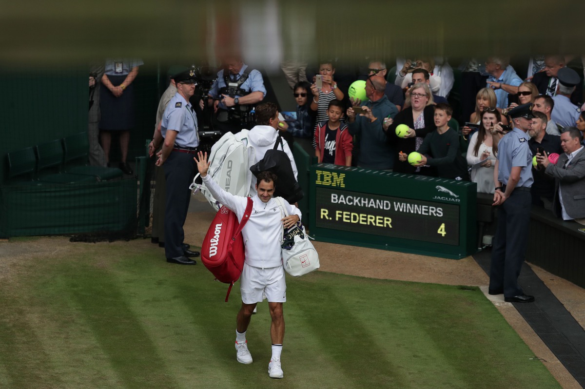 Switzerland's Roger Federer waves to the fans as he leaves the court after winning against Czech Republic's Tomas Berdych during their men's singles semi-final match on the eleventh day of the 2017 Wimbledon Championships at The All England Lawn Tennis Cl