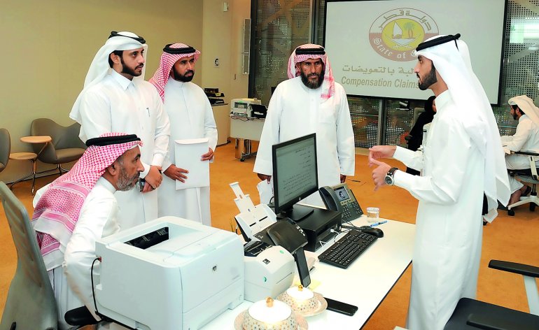 Officials receiving complaints from people at the Compensation Claims Committee headquarters at Doha Exhibition and Convention Center.