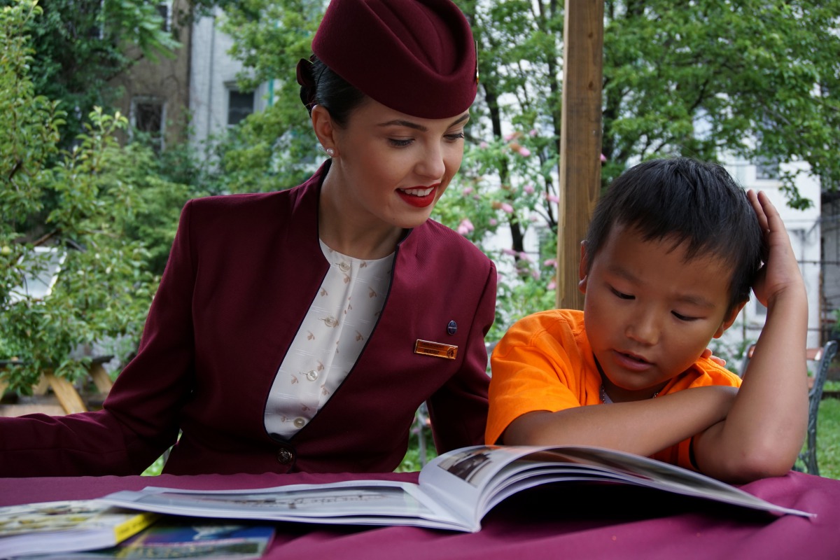 A staff of Qatar Airway interacting with a child during the Qatar Airways Summer Reading Program’ in New York City. 