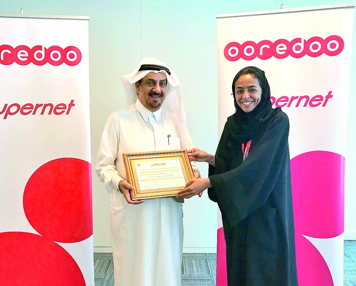 Ooredoo’s Director of PR and Corporate Communications, Manar Khalifa Al Muraikhi, receiving the award from Mohammed Abdulrahman Al Sayed, Best Buddies Qatar Manager of Rehabilitation and Integration Department, at Ooredoo’s headquarters, yesterday.