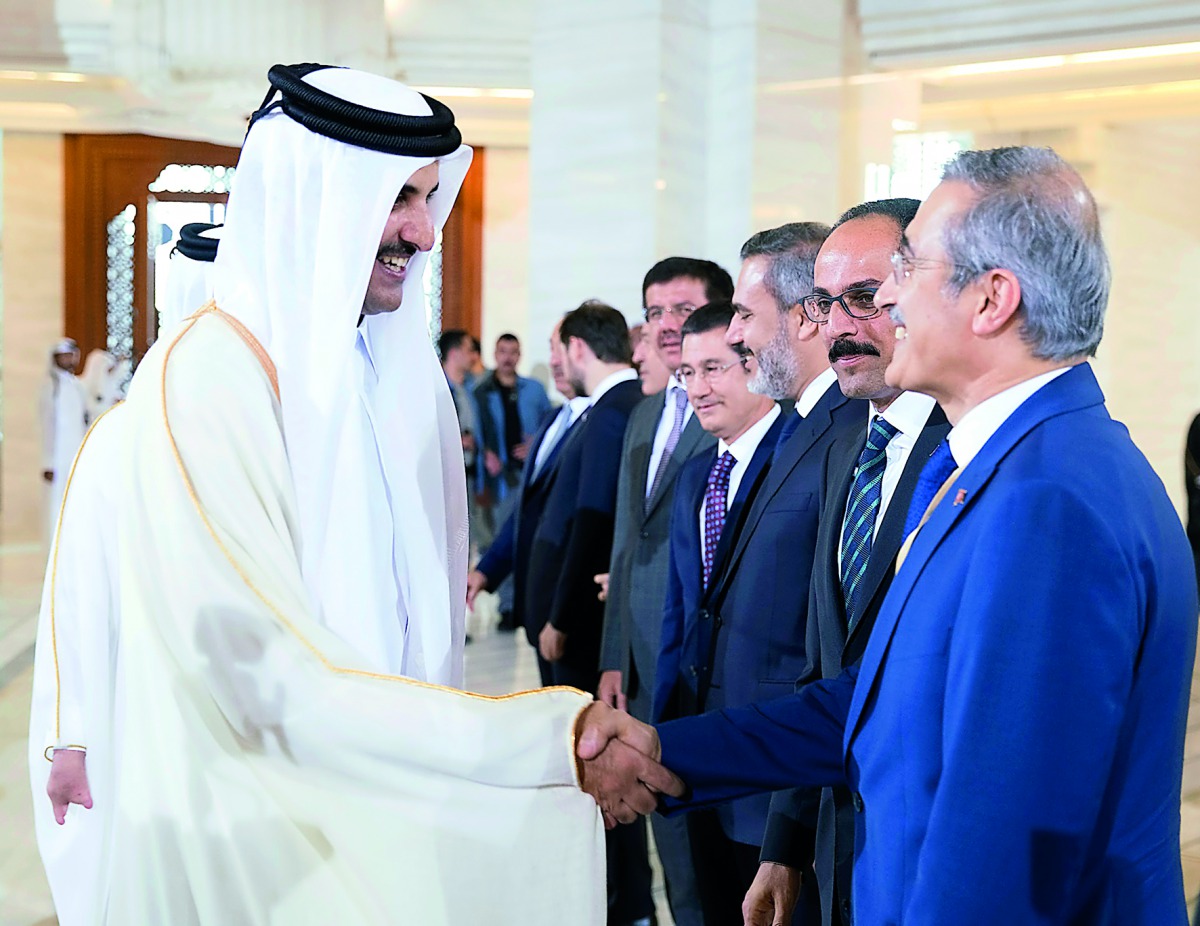 Emir H H Sheikh Tamim bin Hamad Al Thani with Turkish Foreign Minister Mevlut Cavusoglu (right) and members of the accompanying delegation of President of Turkey, Recep Tayyip Erdogan.