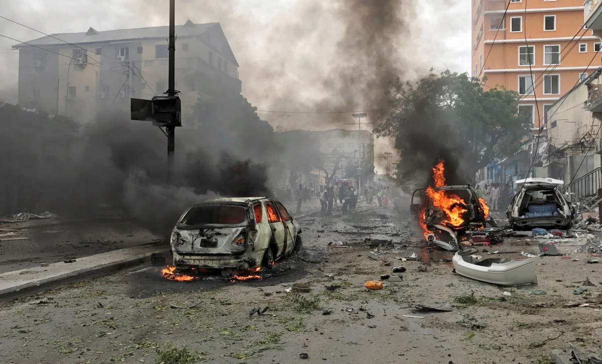 Vehicles burn at the scene of an explosion in Mogadishu, Somalia, July 30, 2017. REUTERS/Feisal Omar
