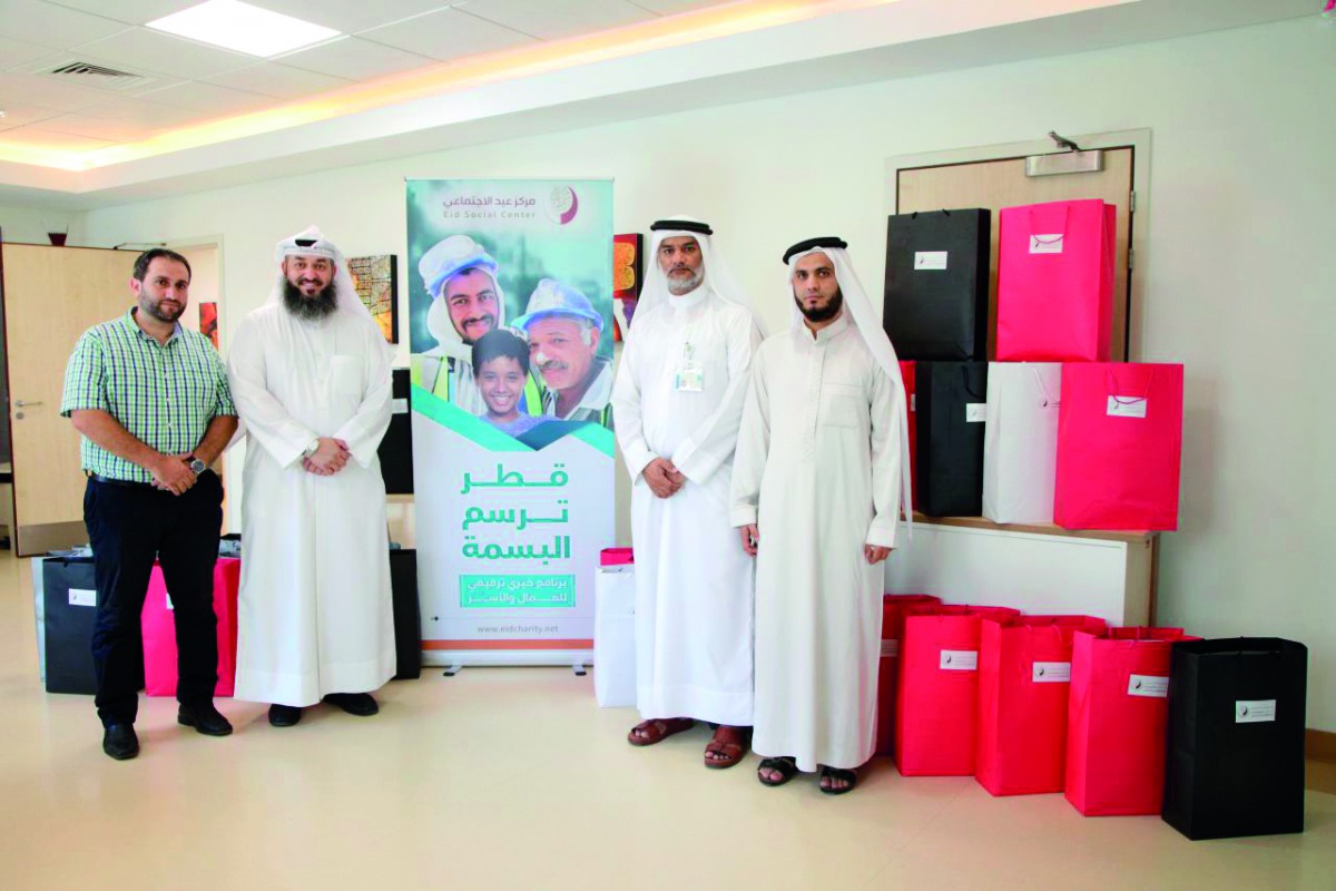 Officials from the Eid Charity at the Long Term Care Unit of HMC as part of the ‘Qatar Draws the Smile’.