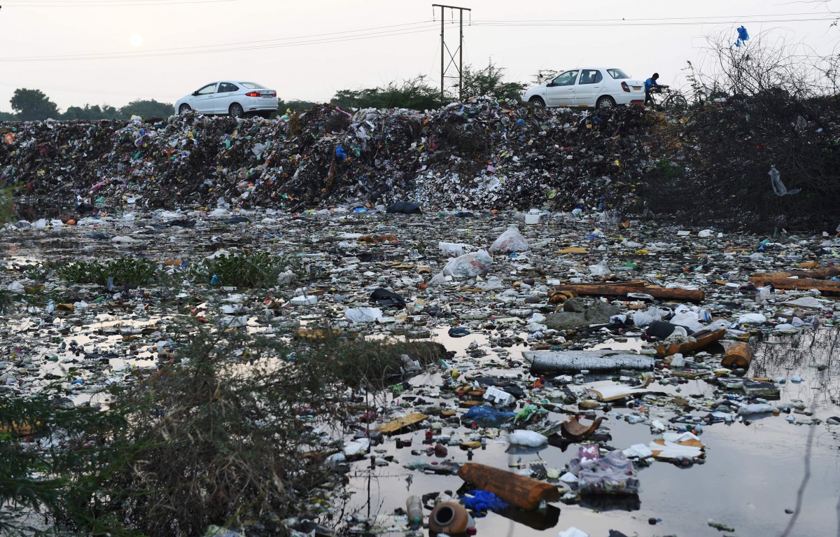A picture taken on August 4, 2017, shows trash accumulated on the outskirts of Madhavnagar village, some 25kms from Ahmedabad, after heavy rains and floods. AFP / Sam Panthaky