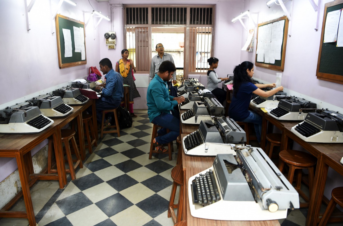In this photograph taken on July 13, 2017, students practise at Abhyankar's Shorthand & Typewriting Institute in Mumbai. AFP / Indranil Mukherjee