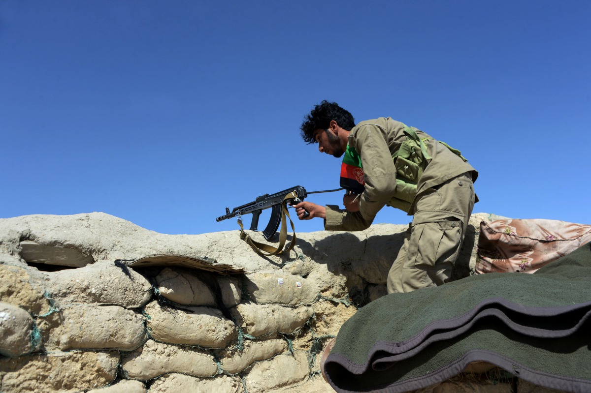 Afghan security forces keep watch near the site of U.S. airstrike on a civilian vehicle in Haska Mina district Nangarhar province on August 12, 2017. (AFP / NOORULLAH SHIRZADA)