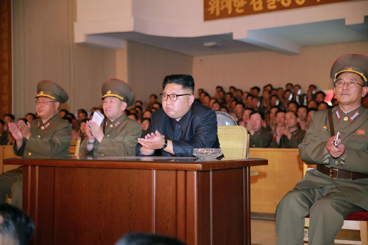 This picture taken on August 14, 2017 and released from North Korea's official Korean Central News Agency (KCNA) on August 15, 2017 shows North Korean leader Kim Jong-Un (C) clapping hands while viewing a stage during his inspecting the Command of the Str