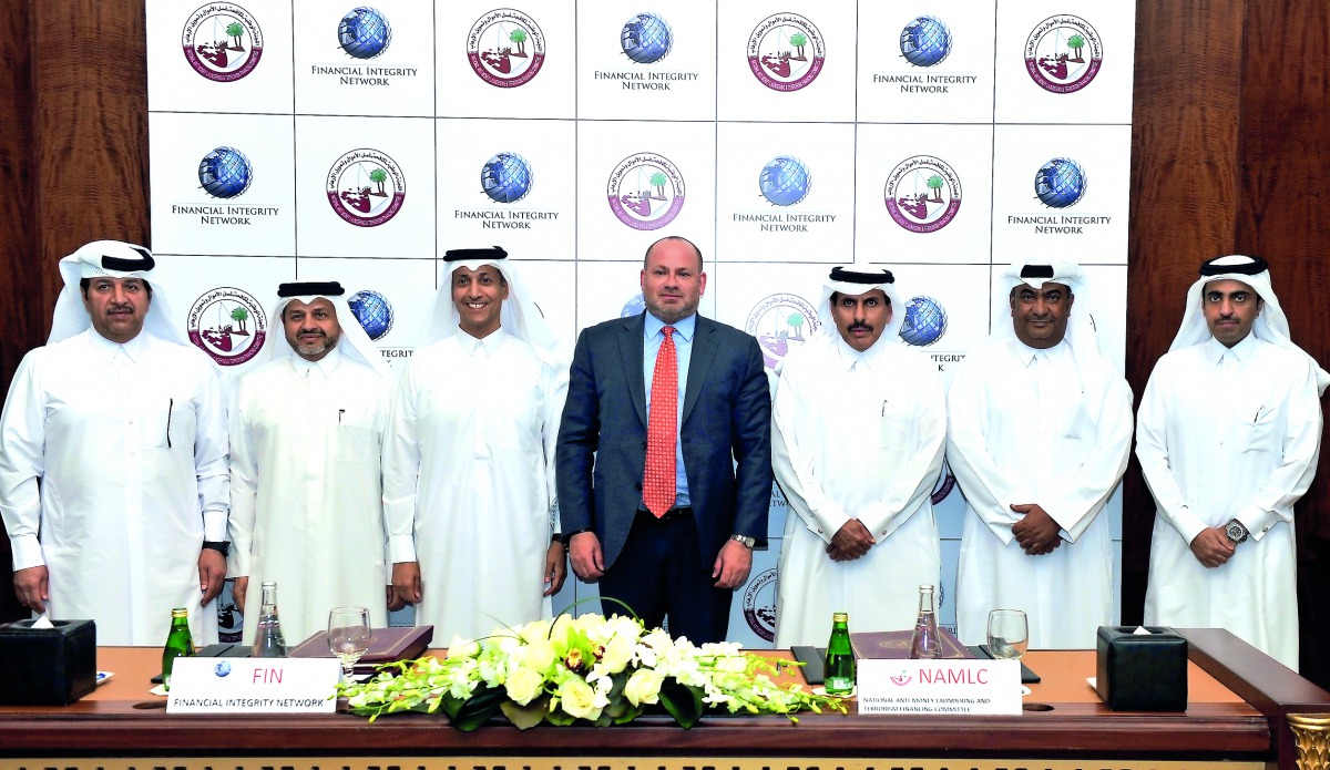 QCB Governor H E Sheikh Abdullah bin Saoud Al Thani (third right), NAMLC Chairman and QCB Deputy Governor Sheikh Fahad Faisal Al Thani (third left), with Daniel L Glaser (centre) of FIN and other officials at the signing ceremony. Pic: Kammutty VP / The P