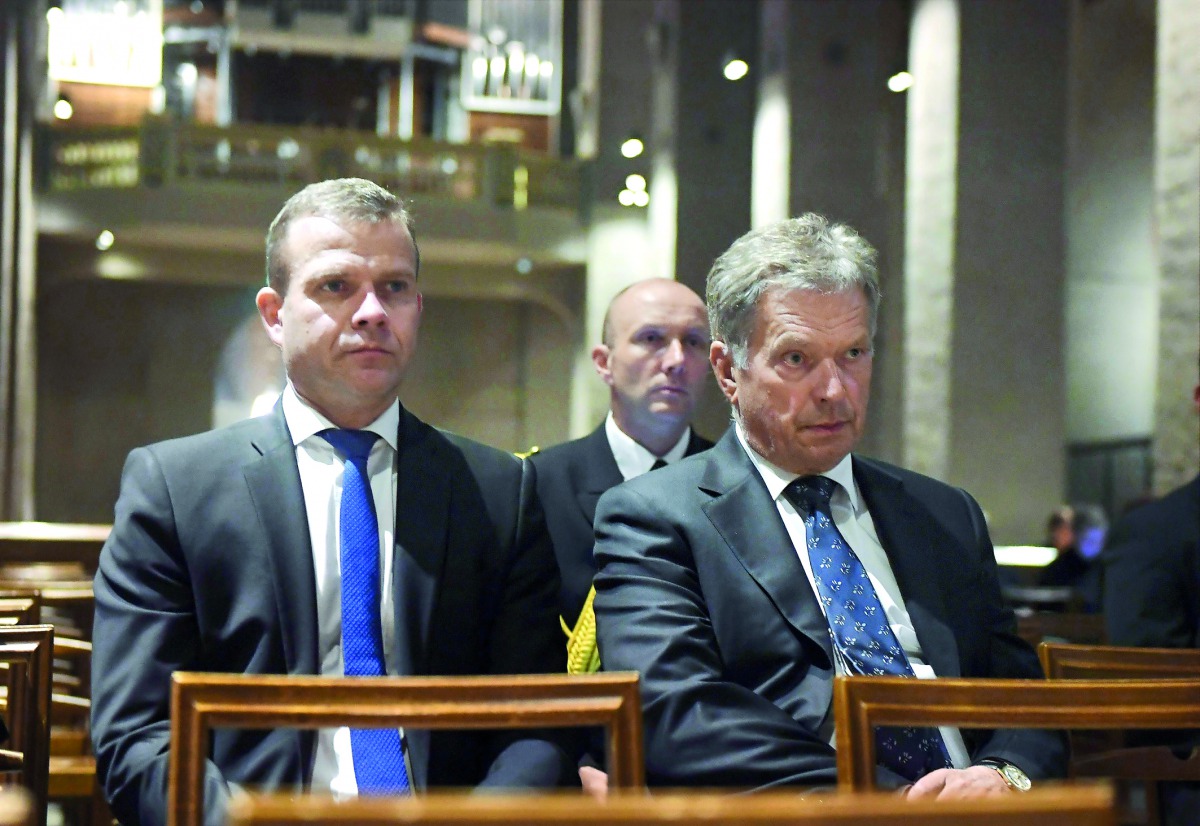 President of Finland Sauli Niinisto and Finland's Minister of Finance Petteri Orpo (L) attend a prayer service at the Turku Cathedral for the victims of Friday's stabbings in Turku, Finland where several people were stabbed on August 18, 2017. AFP / Lehti