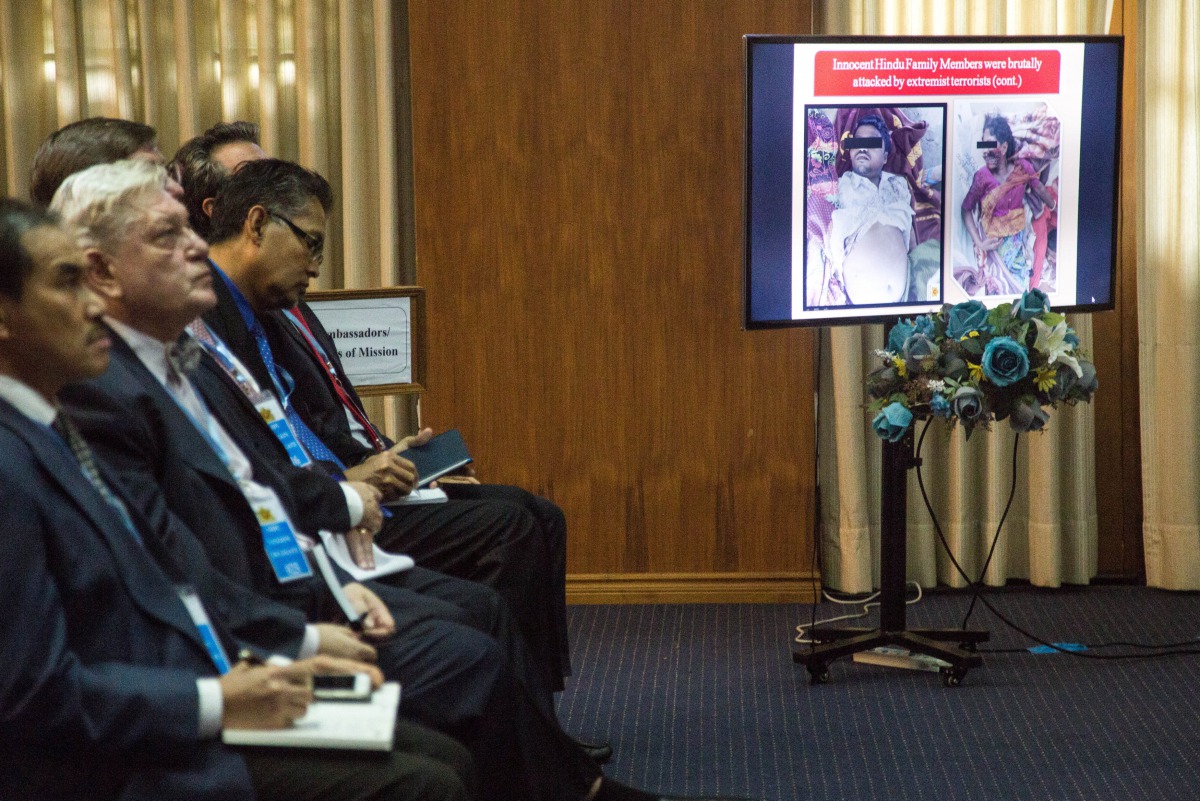 Pictures of victims of violence in the state of Rakhine are displayed on a screen during a news conference held by National security Advisor U Thaung Tun at National reconciliation and peace center office in Yangon, Myanmar August 29, 2017. Reuters