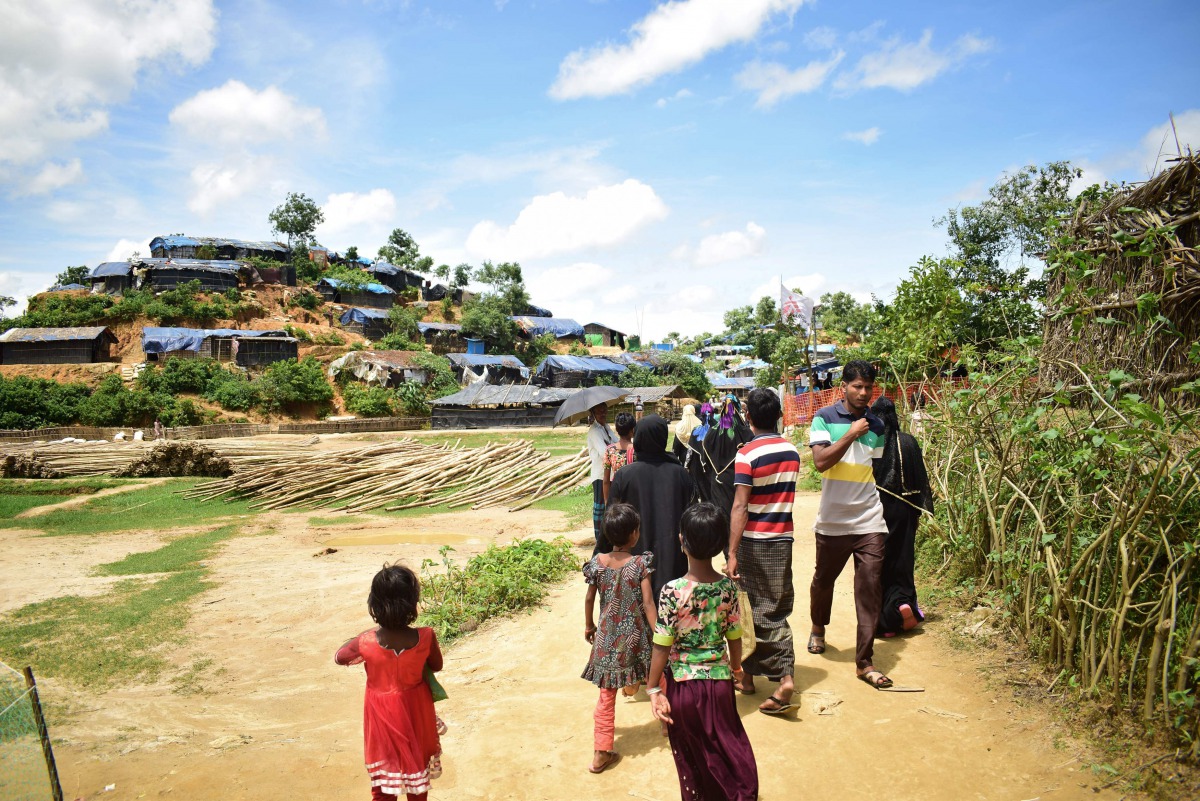 Newly arrived Rohingya refugees walk past the Balukhali Rohingya camp near Ukhiya on the Bangladesh border, on August 27, 2017,  after violence erupted in bordering Myanmar's Rakhine state. AFP / Sam Jahan