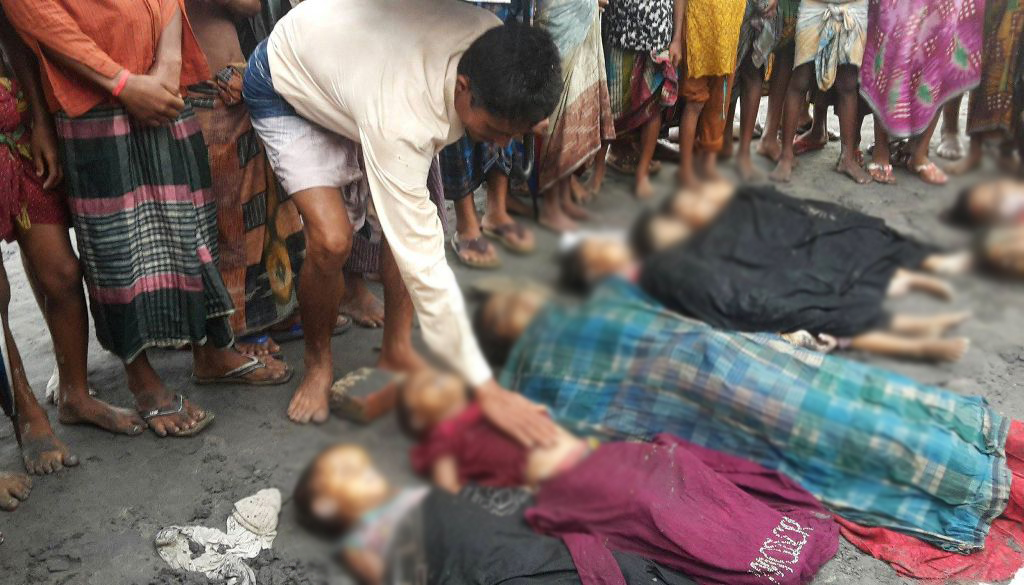  A Bangladeshi man touches the body of a Rohingya child on August 31, 2017, one of a number of people who drowned after their boat capsized on the Naf river estuary near Teknaf. At least 18,500 Rohingya have crossed into Bangladesh since fighting erupted 