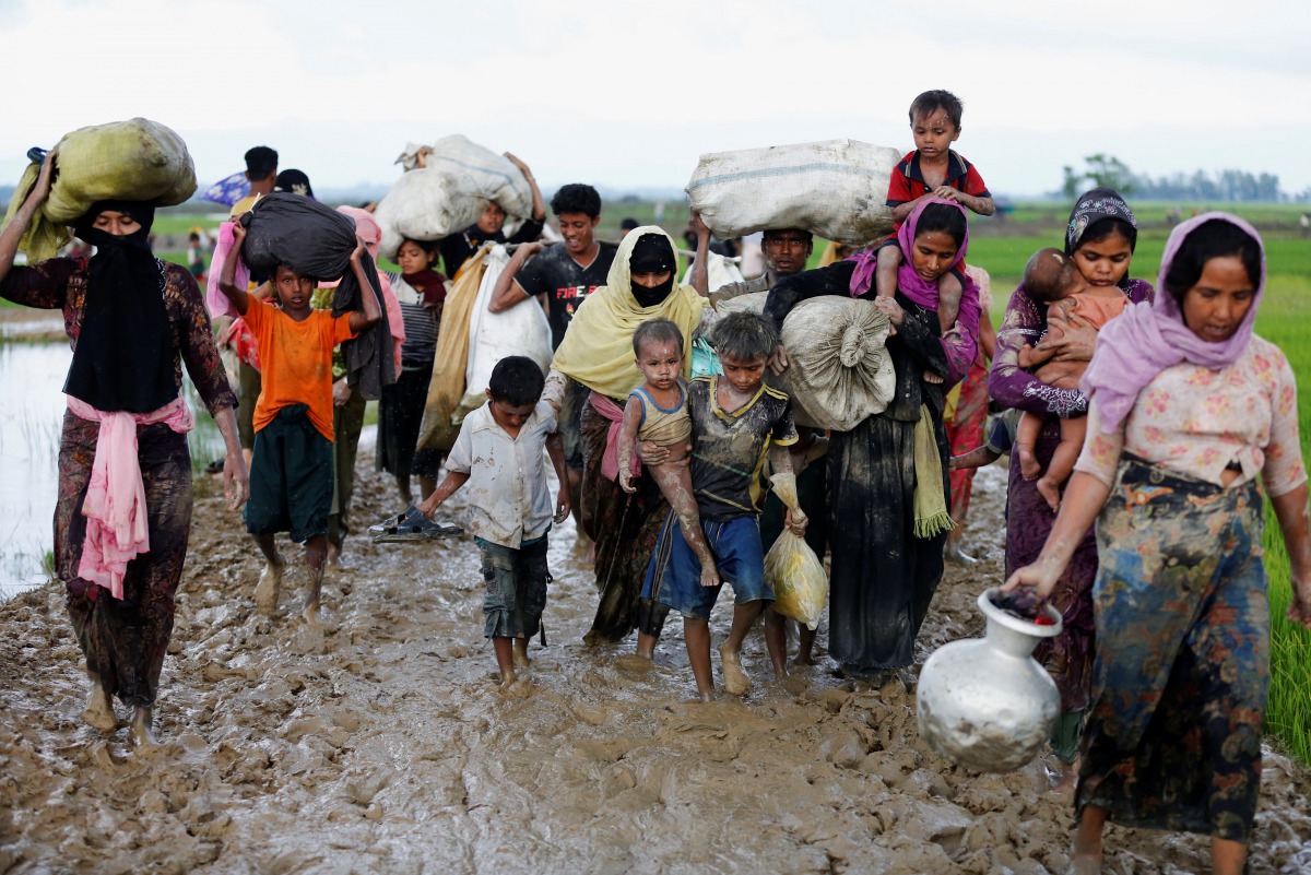 A group of Rohingya refugees walk on the muddy road after travelling over the Bangladesh-Myanmar border in Teknaf, Bangladesh, September 1, 2017. (REUTERS/Mohammad Ponir Hossain)