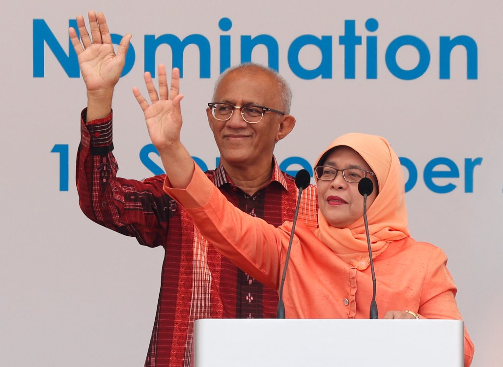 Singapore's President-elect Halimah Yacob and her husband Mohammed Abdullah Alhabshee address supporters before leaving the nomination centre in Singapore September 13, 2017. REUTERS/Edgar Su