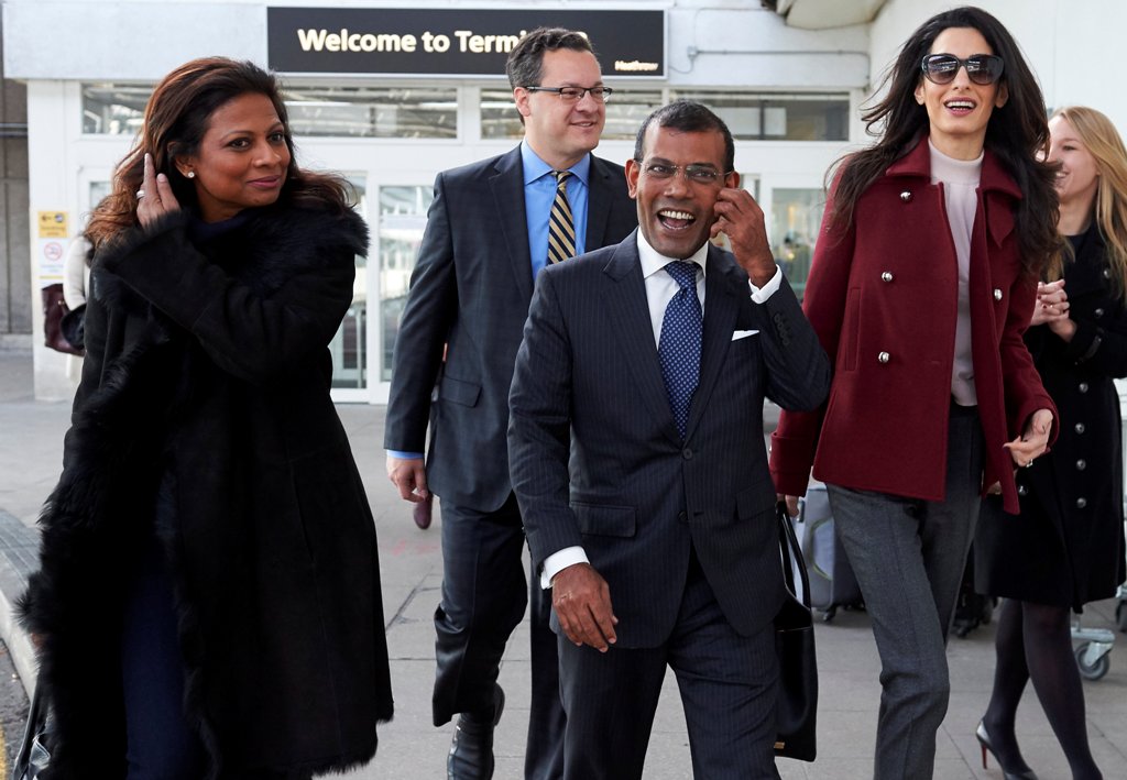 (FILES) In this photograph taken on January 21, 2016, former Maldives president Mohamed Nasheed (C), his wife Laila Ali (L) and British lawyer Amal Clooney look on after Nasheed arrived at Heathrow airport in London.   AFP / NIKLAS HALLE'N