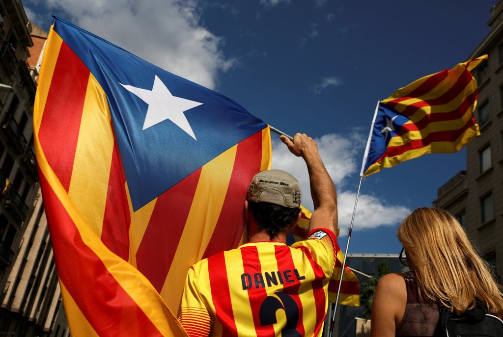 People wave Estelads (Catalan separatist flag) as they gather ahead of a rally on the regional national day 'La Diada' in Barcelona, Spain, September 11, 2017. REUTERS/Susana Vera 